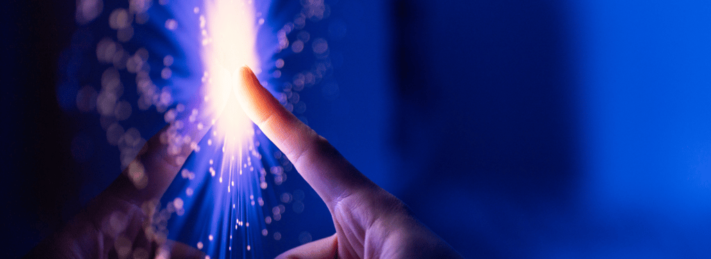 A finger touching a digital interface, which lights up on touch