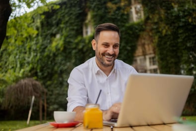 Man working on his laptop in the garden