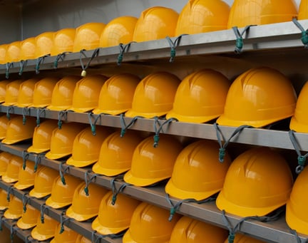 yellow hard hats on shelves