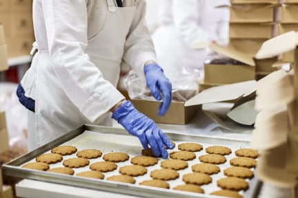 Chef removing freshly baked cookies from the baking tray